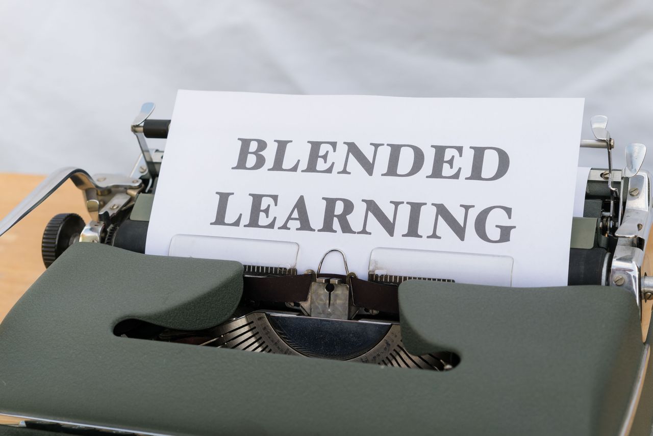 Close-up of a vintage typewriter typing 'Blended Learning', symbolizing the integration of traditional and digital education.