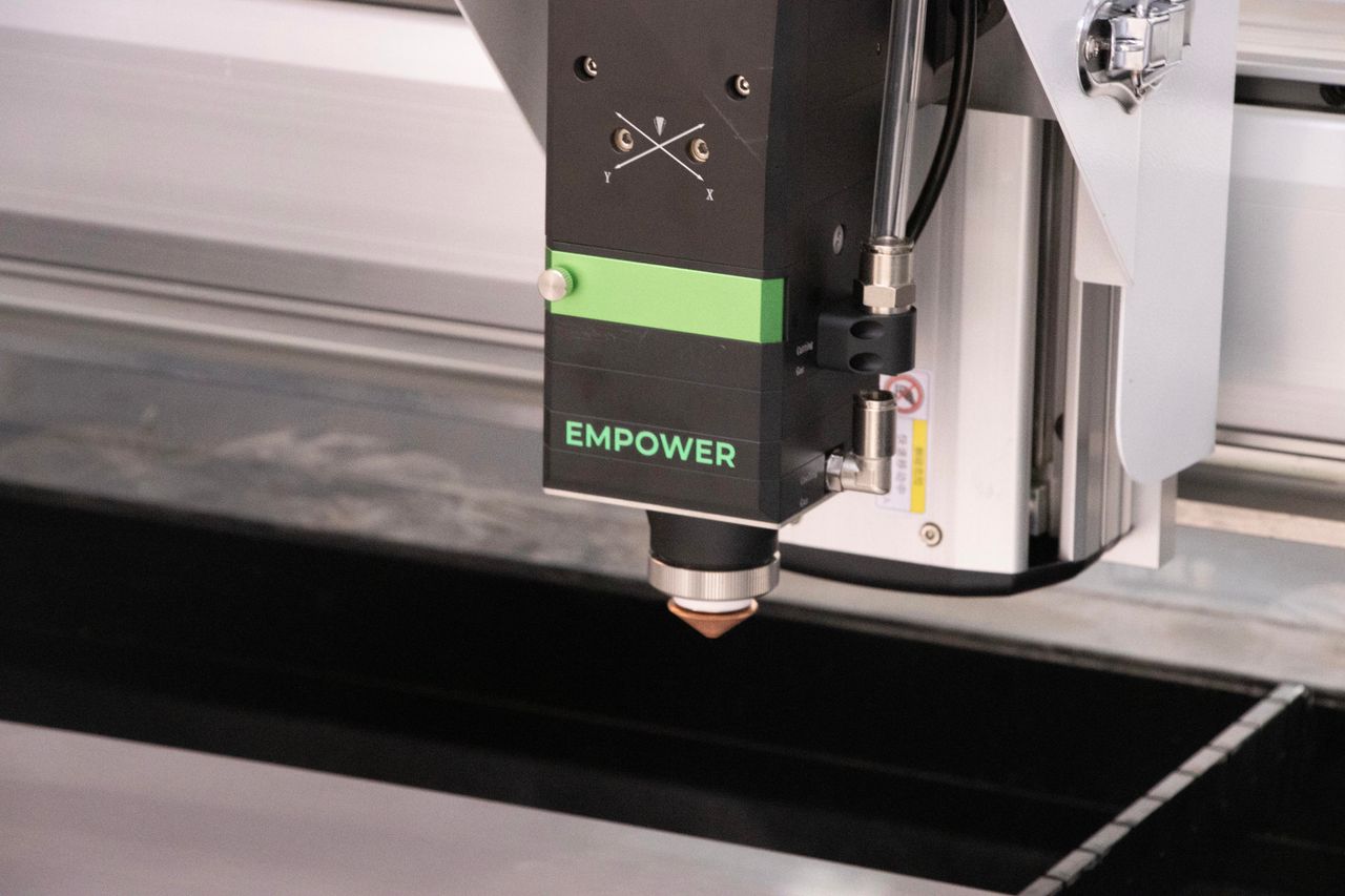 High-resolution image of an industrial laser cutter head used in precision manufacturing.
